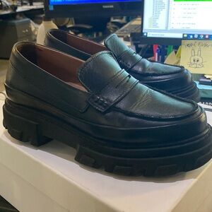 Ganni loafer shoes in black size 8. There is a small tear on the left shoe.